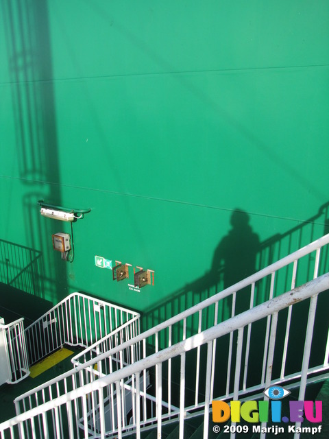 SX03022 My shadow standing on stairs on green shimney